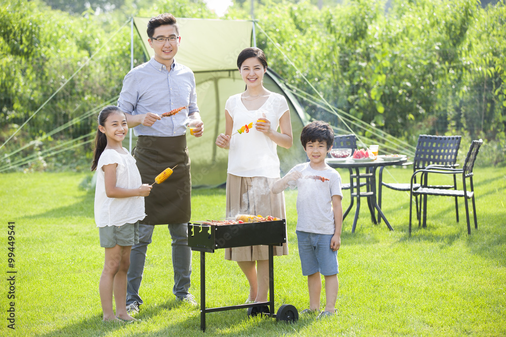 Young family barbecuing outdoors