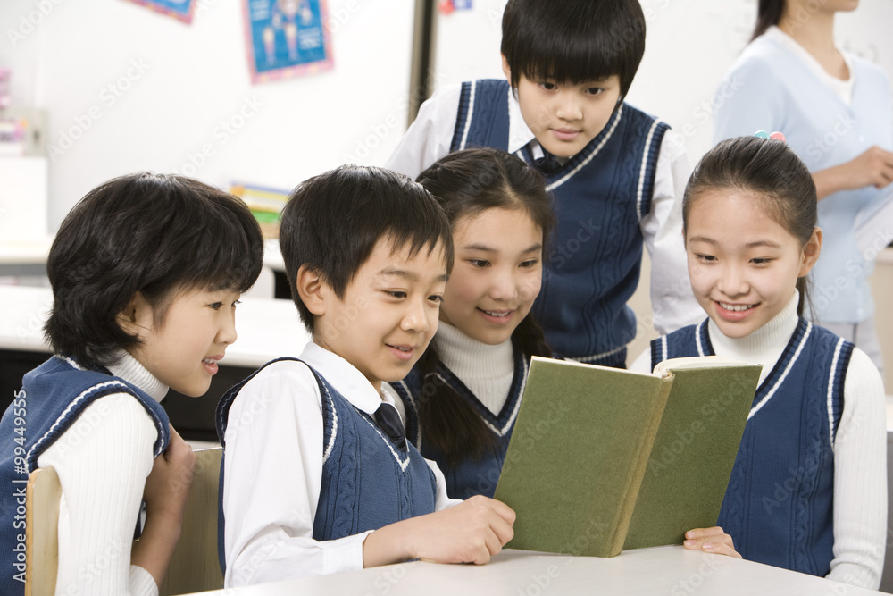 Students reading a book together