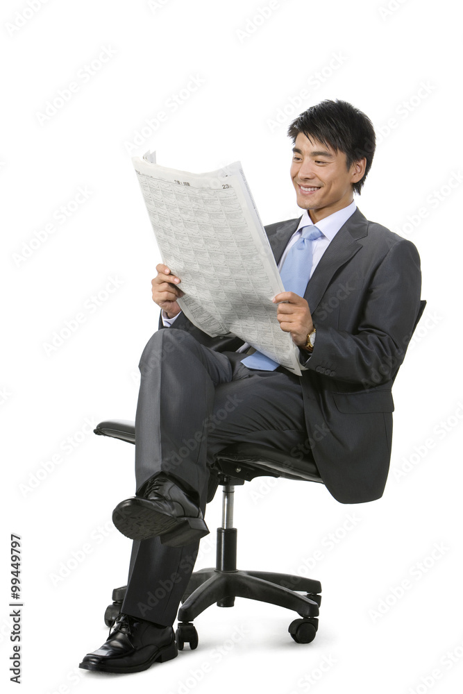 Young Businessman reading newspaper