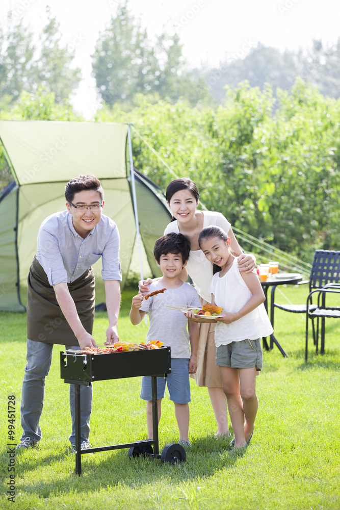 Young family barbecuing outdoors