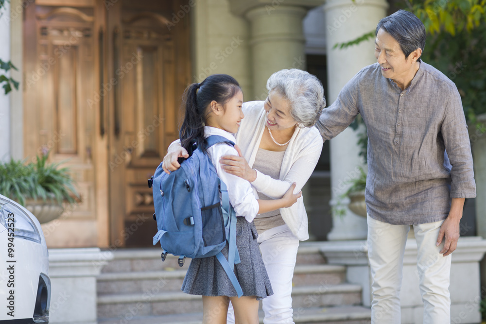 Schoolgirl running into grandmothers arms