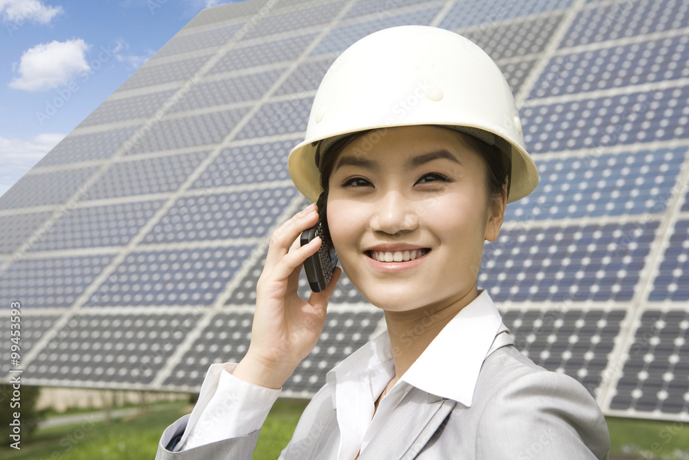 Portrait of an engineer in front of solar panels