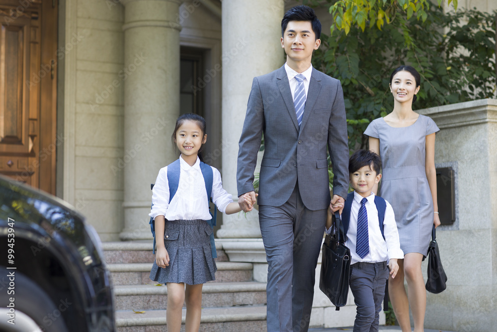 Young couple sending their children to school