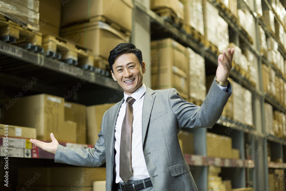 Cheerful businessman in warehouse