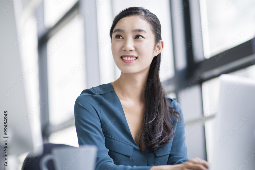 Young businesswoman working in office