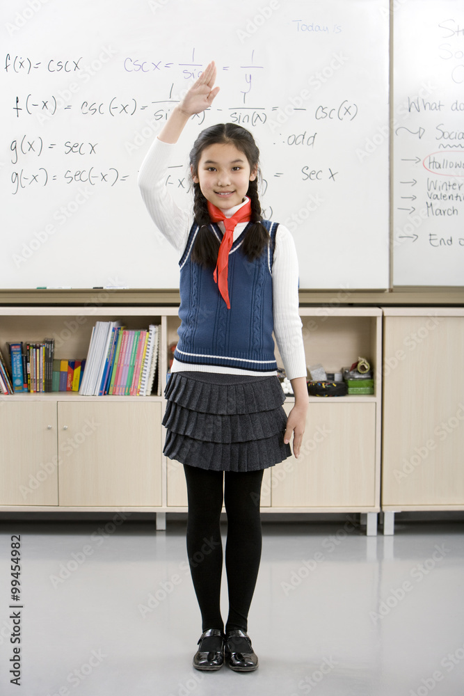 Young student saluting in front of whiteboard