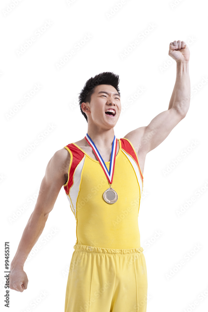 Athlete with a medal punching the air for winning