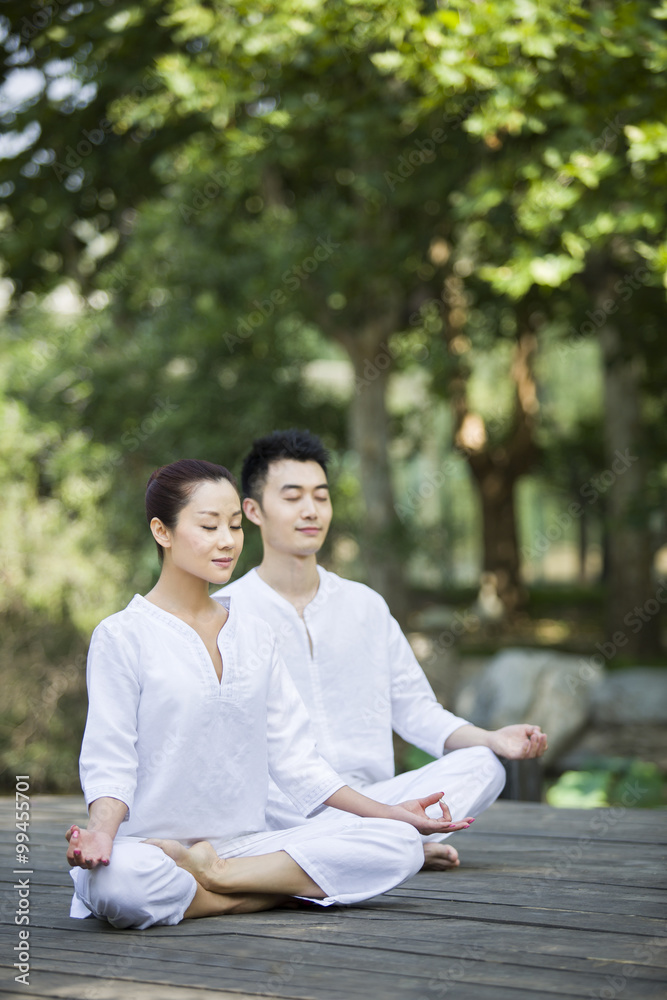 Young couple practicing yoga