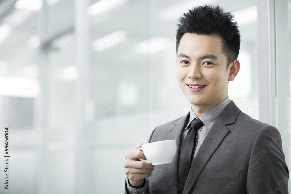 Happy businessman having coffee