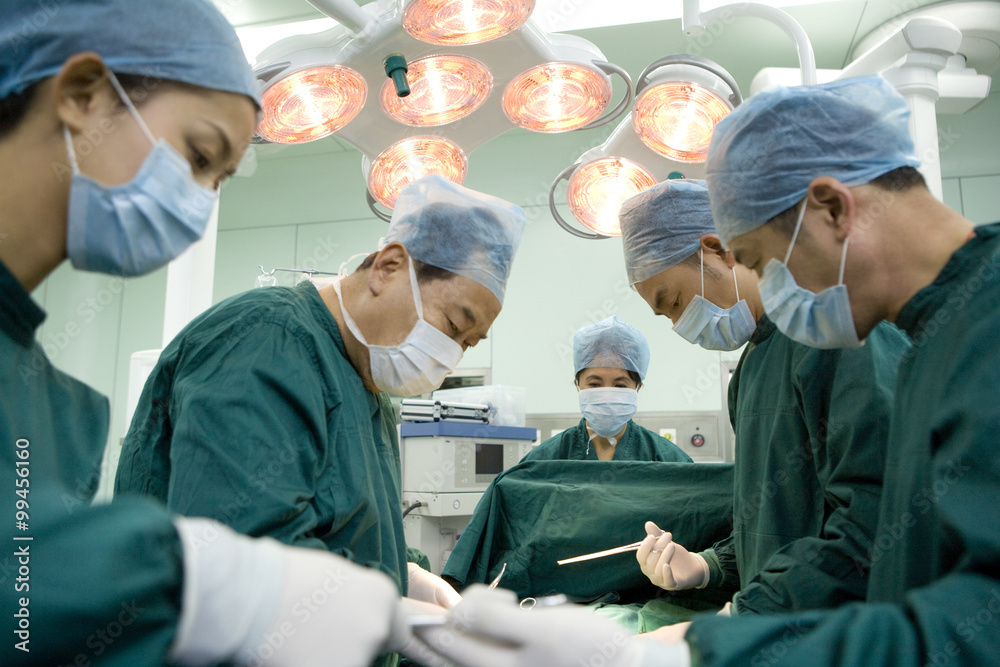 Team of surgeons working in an operating room