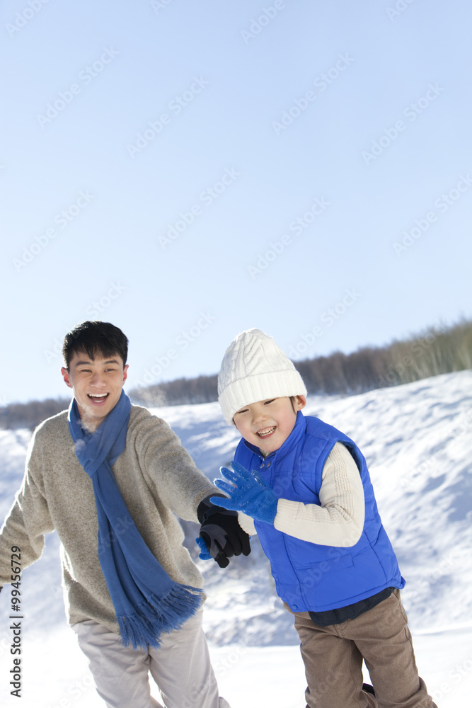 Father playing with son in snow