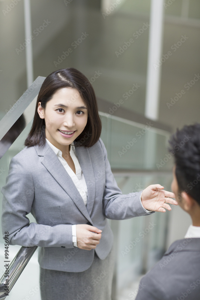 Business person talking on the stairs