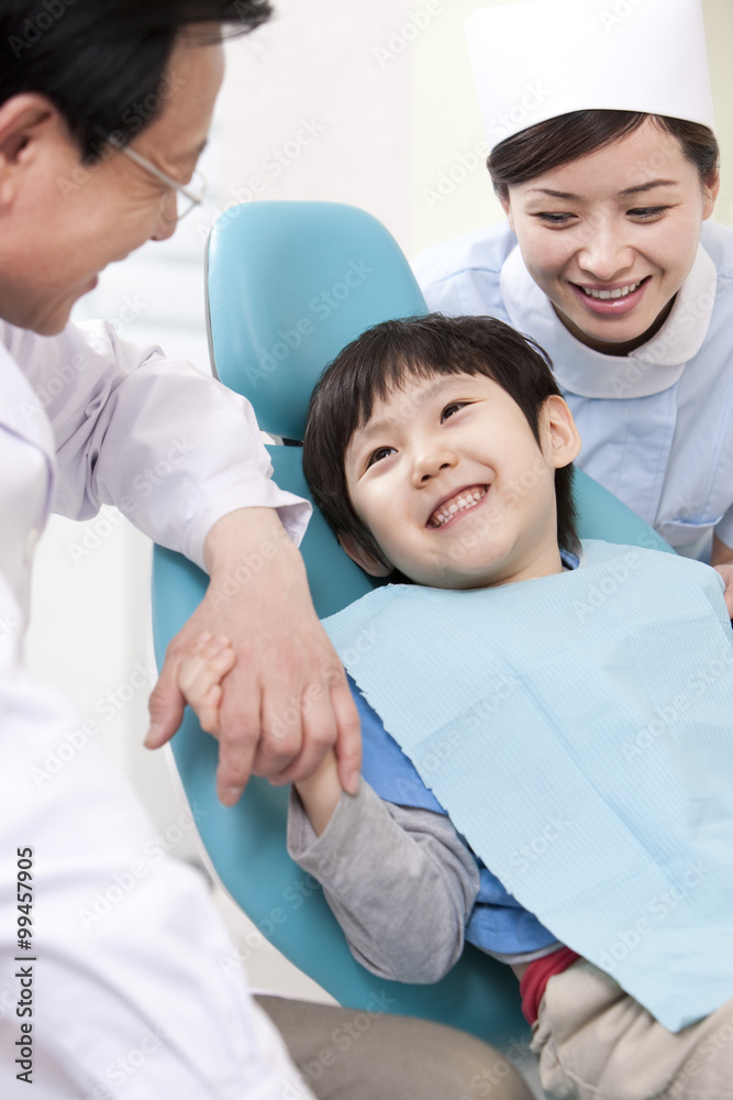 Little patient receiving treatment in dental clinic