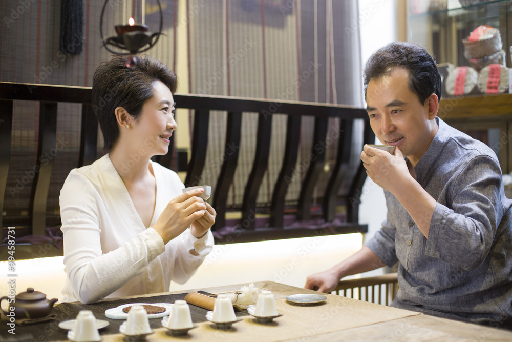 Friends drinking tea and talking in tea room