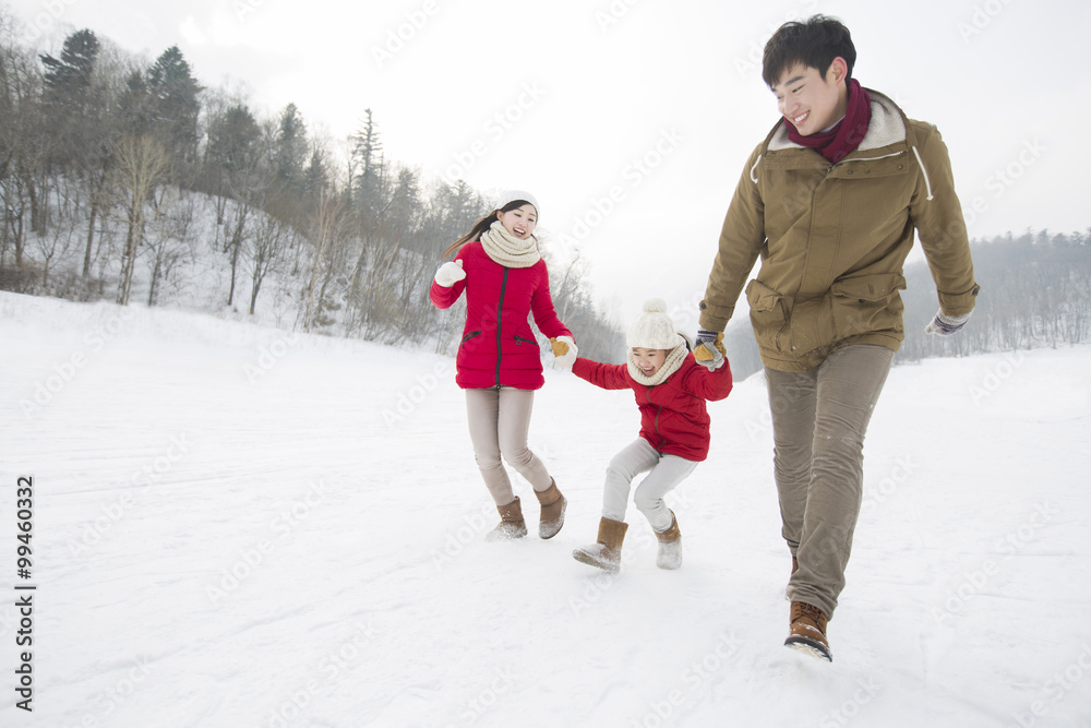 Happy family playing on the snow