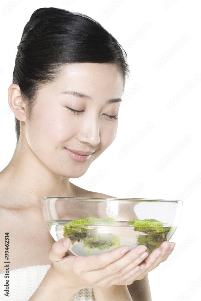 Beautiful young woman holding a bowl