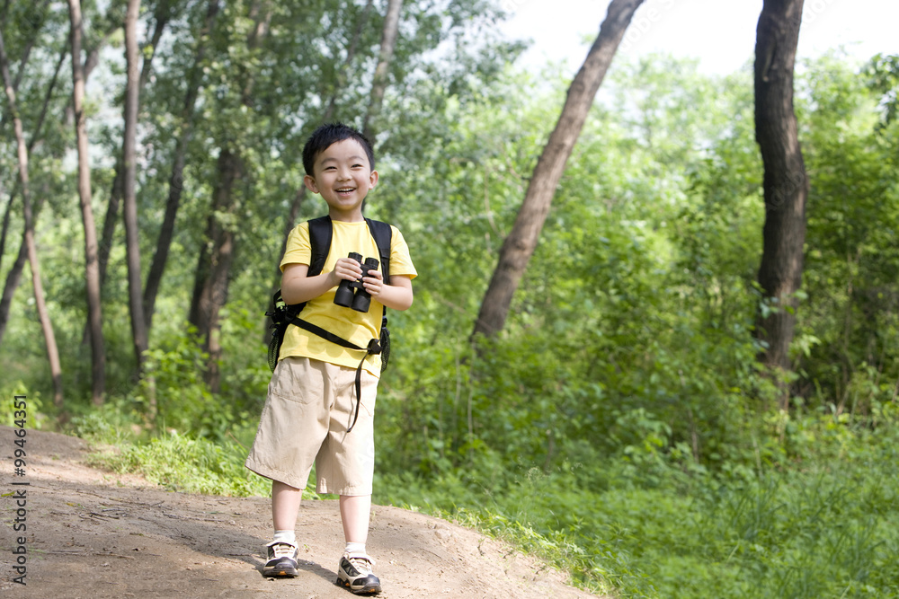 Young boy looking through binoculars