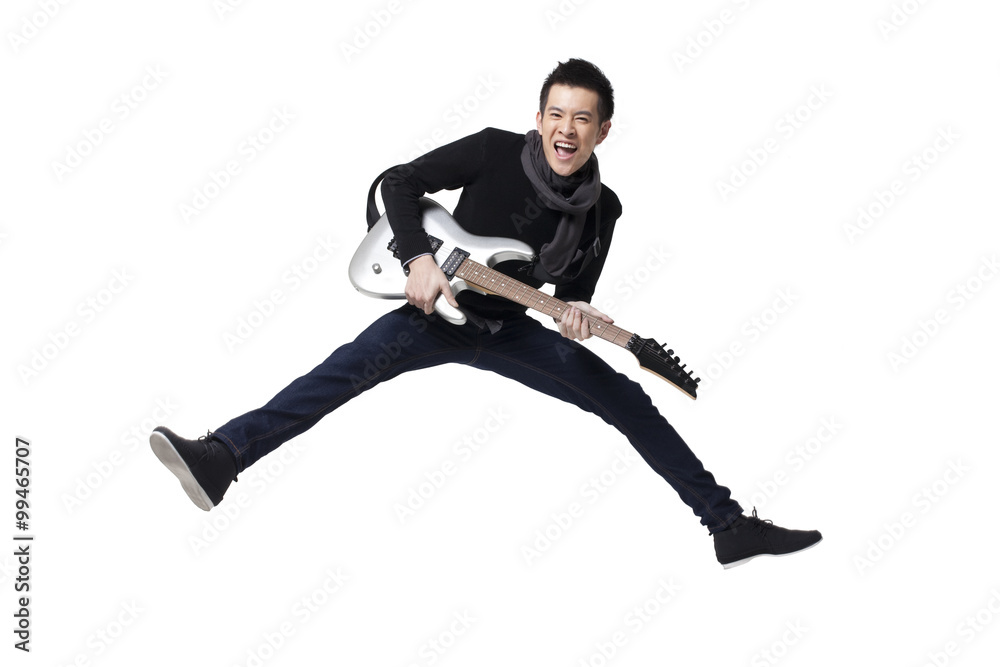 Stylish young man playing guitar