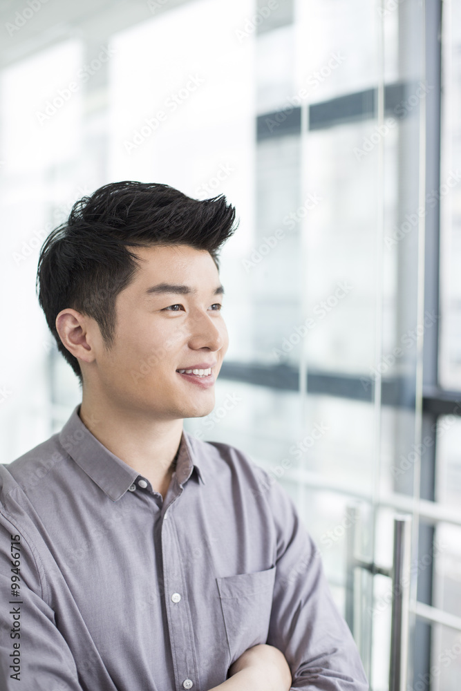 Young businessman thinking in office