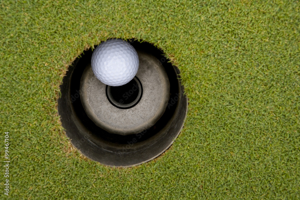 Close-up of golf ball in hole