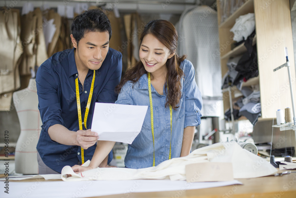 Two fashion designers working in studio