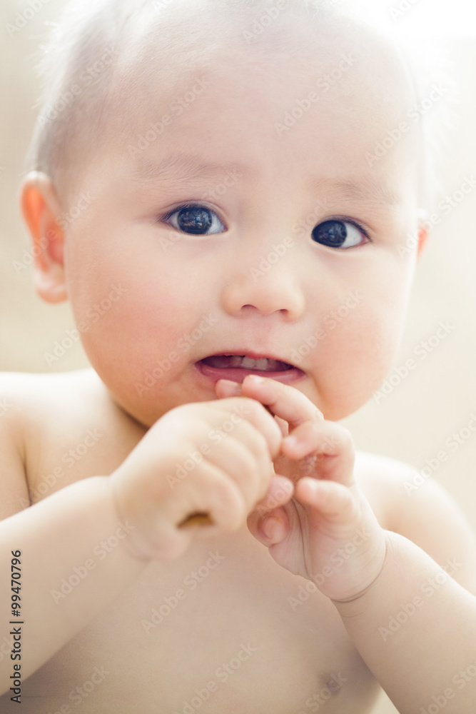 Cute baby boy eating biscuit