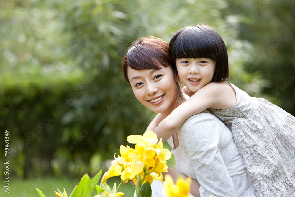 Mother and daughter having fun in garden