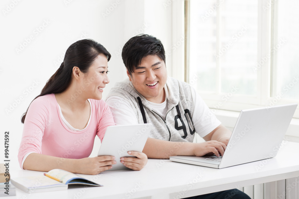 Young college students surfing the net in classroom