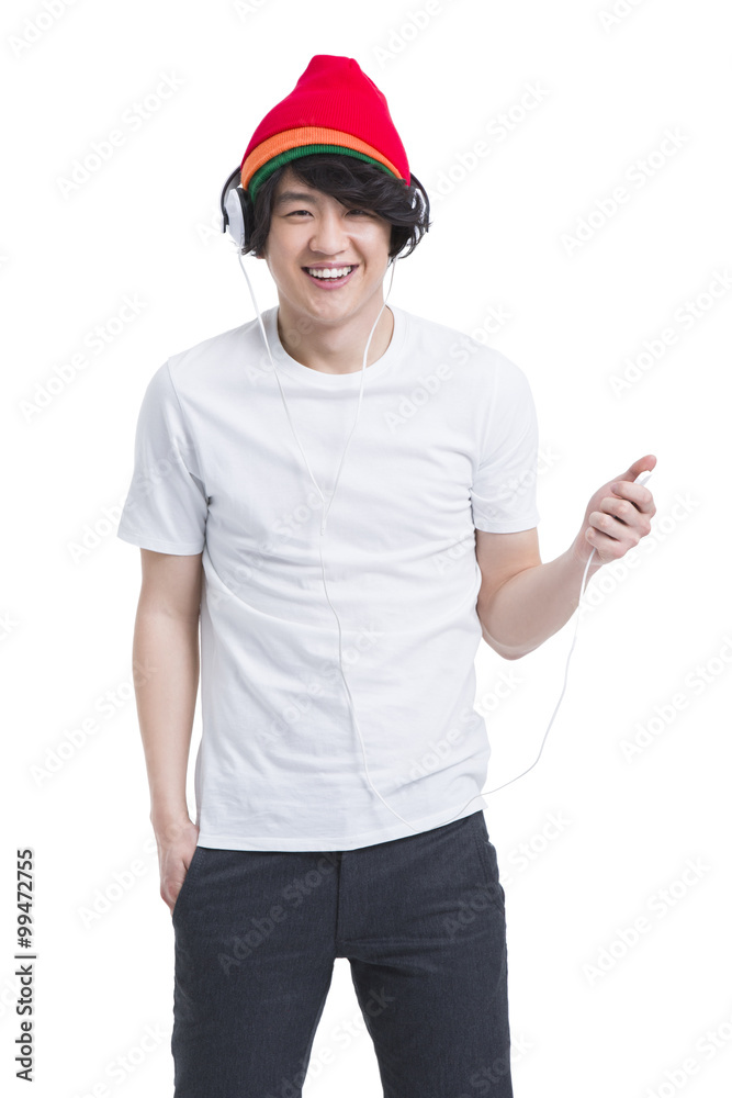 Fashionable young man listening to music