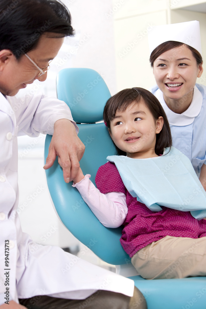 Little patient receiving treatment in dental clinic