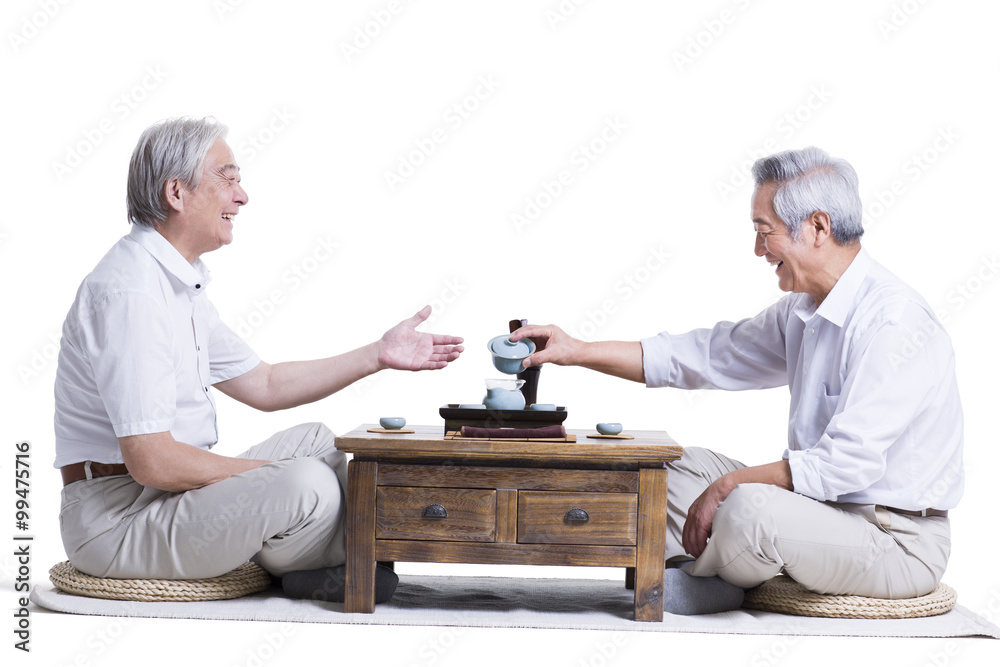 Male senior friends having tea