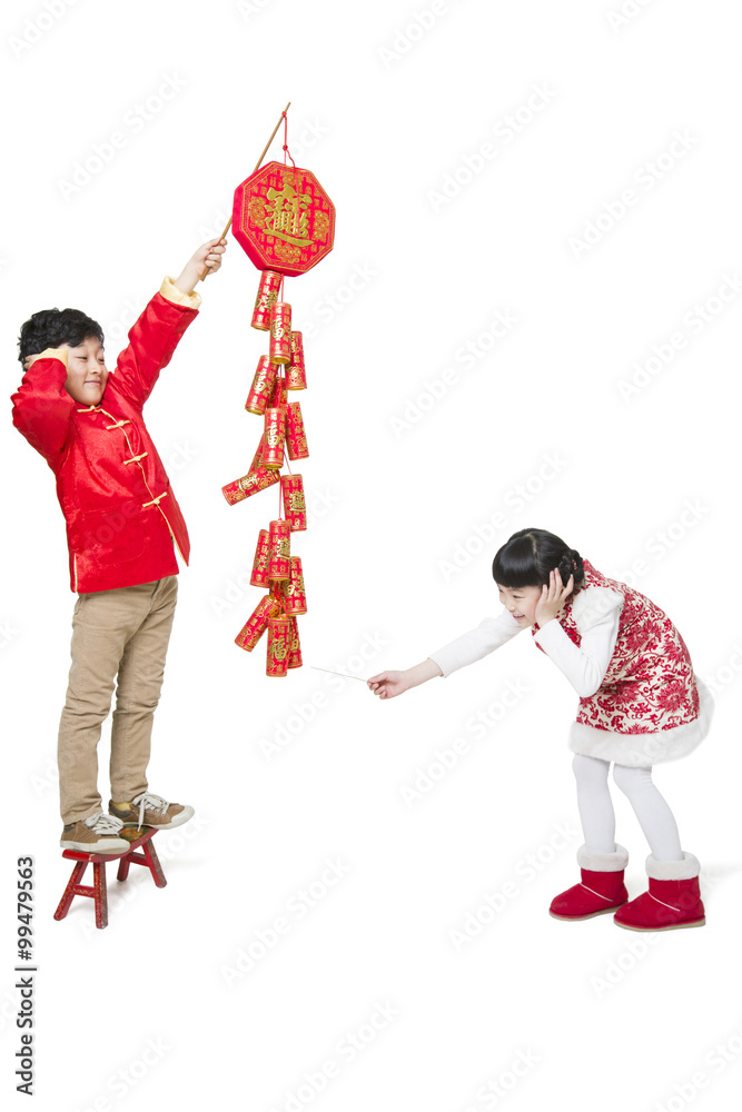 Happy children celebrating Chinese new year with petard