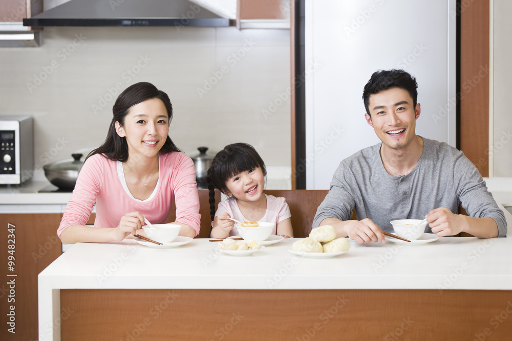 Happy family having breakfast