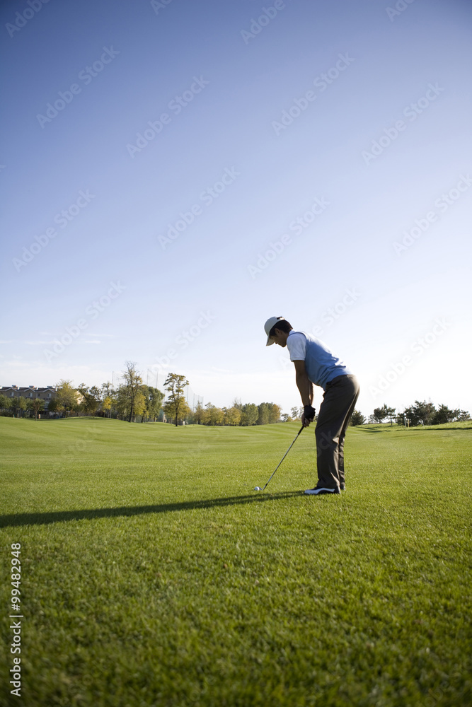 Man teeing off on the course