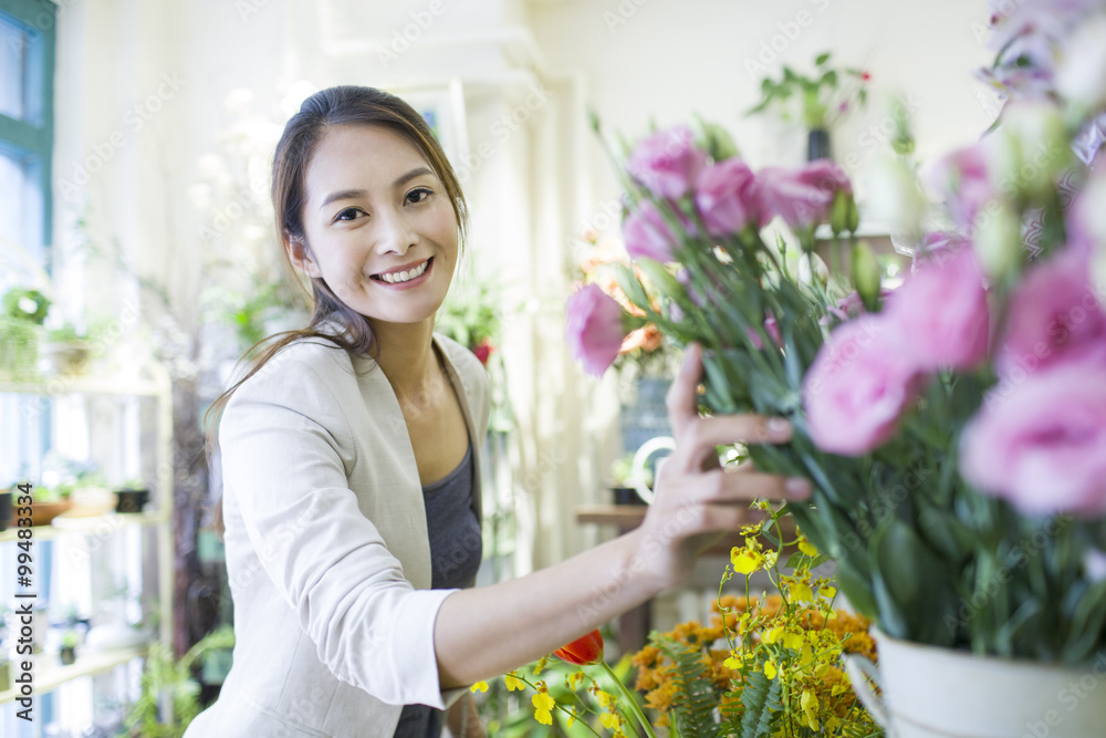 Young woman buying flowers