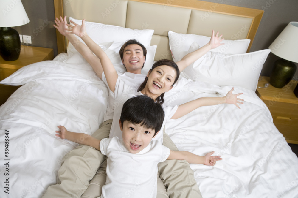 Portrait of a young family on a bed