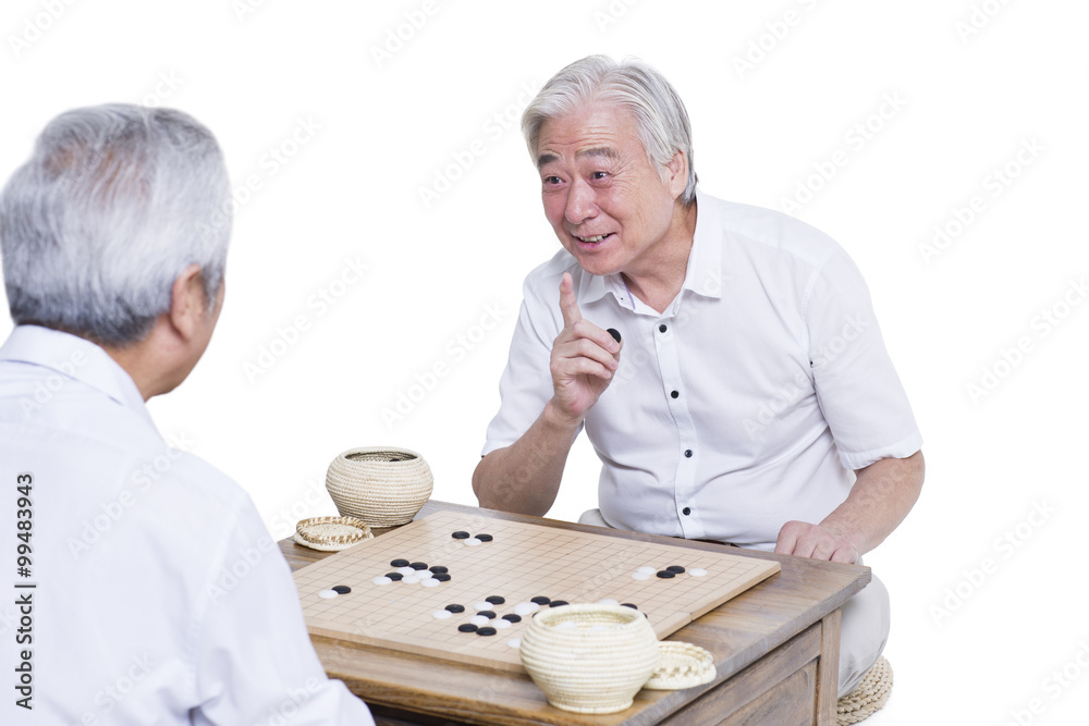 Male senior friends playing go