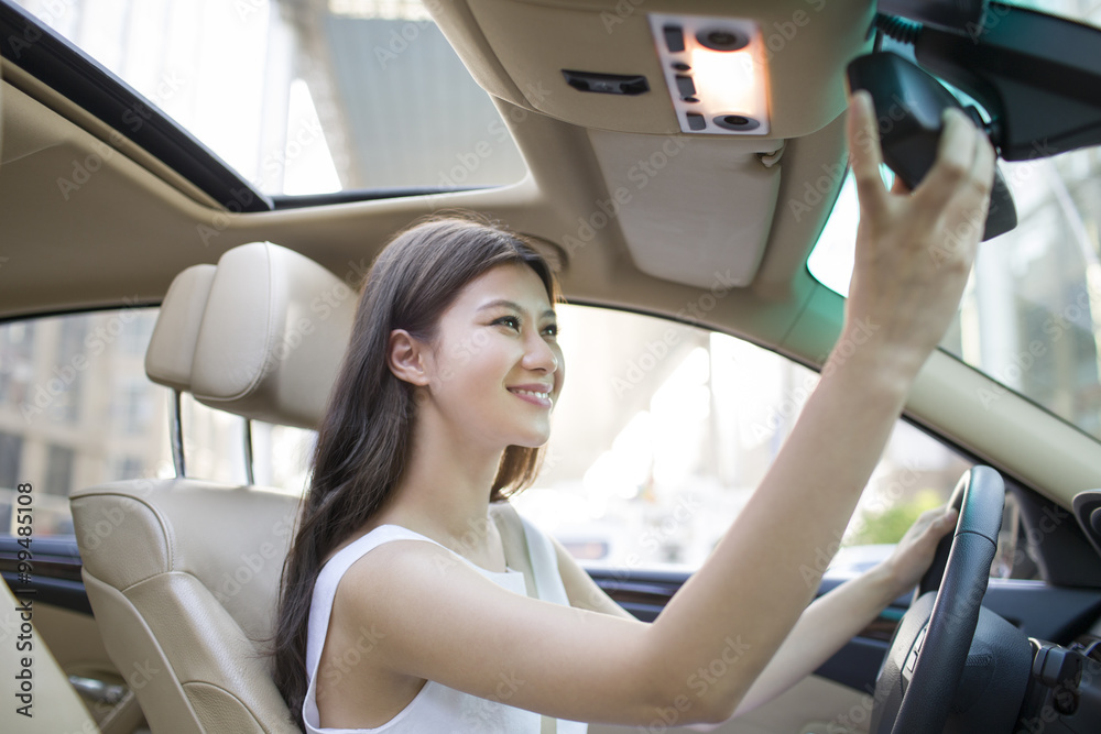 Young woman driving car