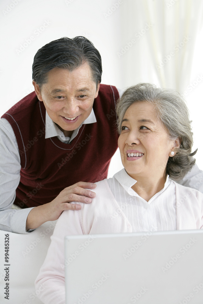 Senior Chinese couple using a laptop