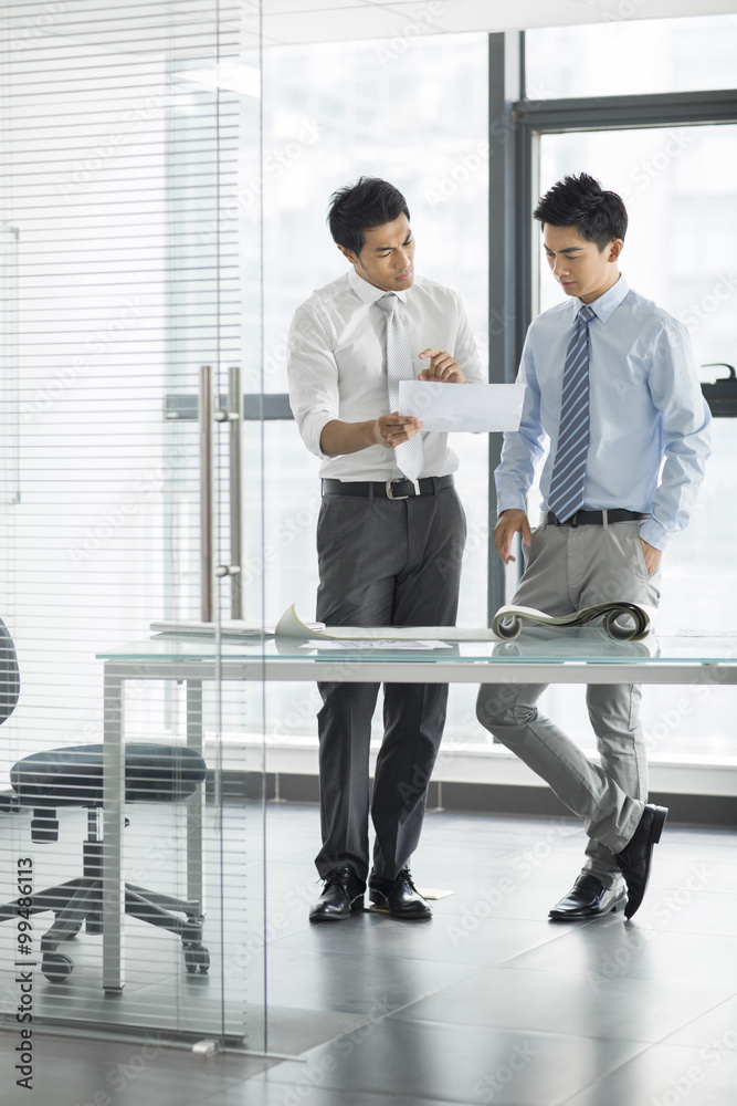 Young businessmen talking in office