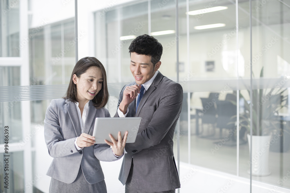 Business person looking at digital tablet together