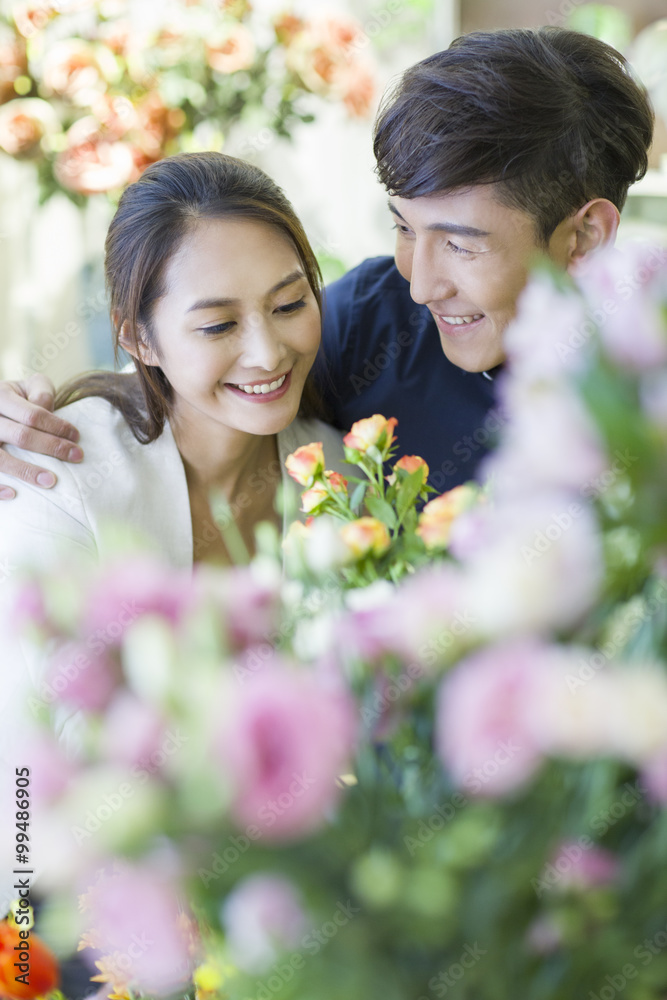 Young couple buying flowers