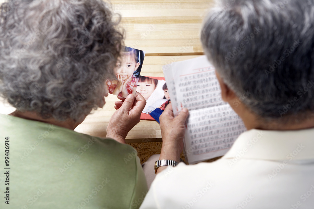 Elderly Couple Reading A Letter Together