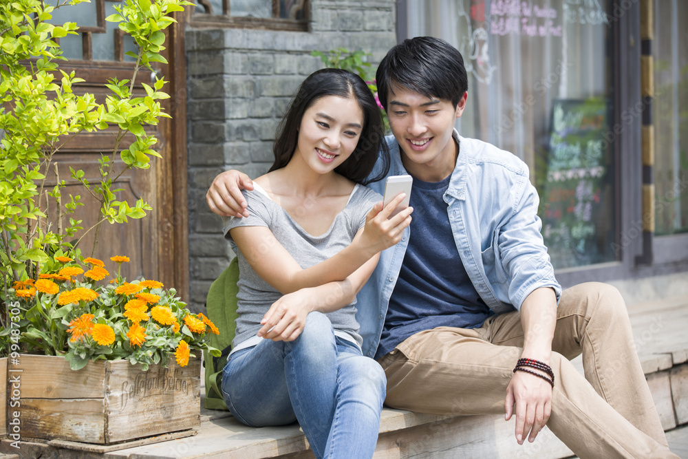 Young couple using smart phone