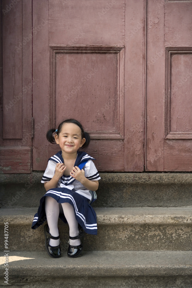 A child in her school uniform