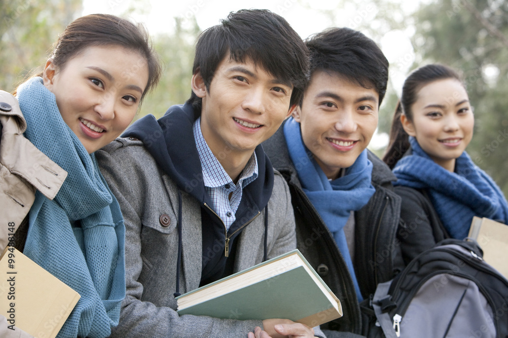 A group of college students hanging out with books