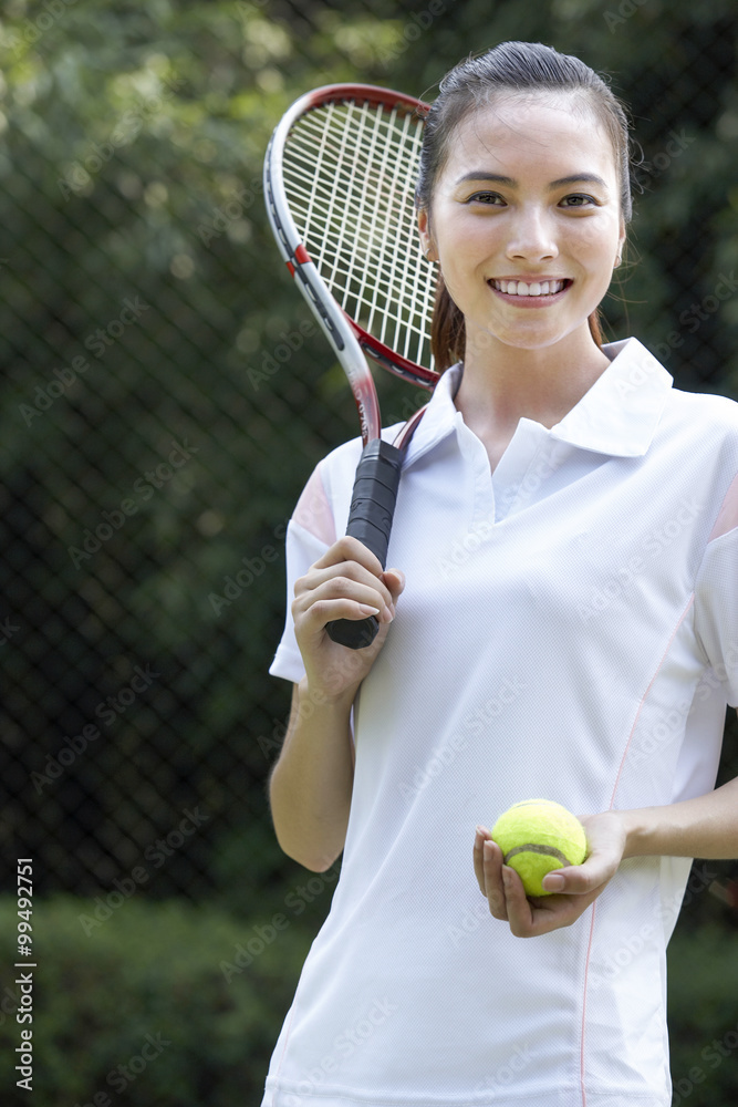 Portrait of a young couple on the tennis court