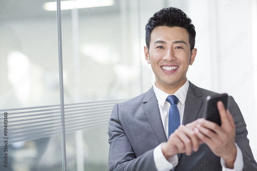 Young businessman using smart phone