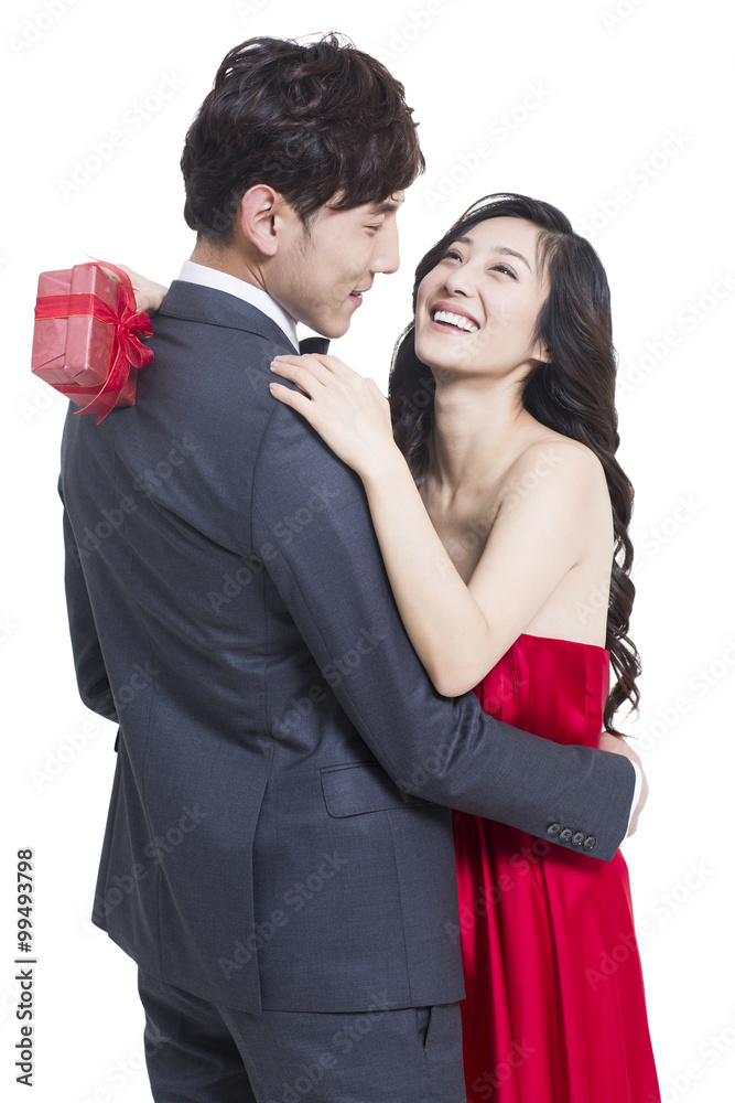 Young woman hugging boyfriend after receiving a gift