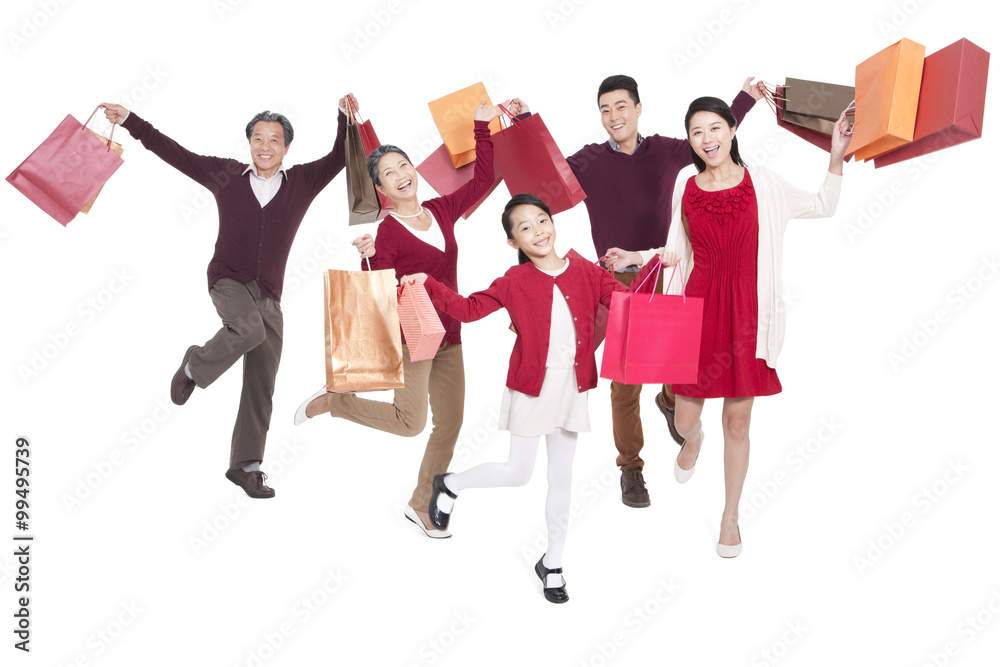 Cheerful family jumping in mid-air with shopping bags